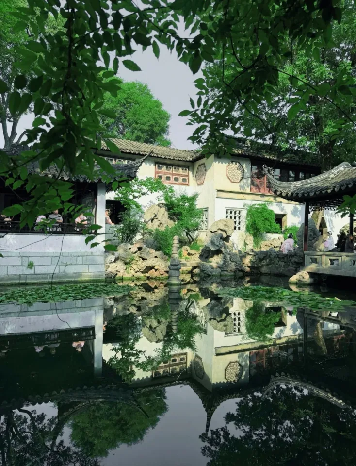 Lingering Garden: still water mirroring pavilions, rockery and trees
